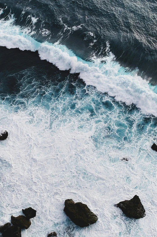 a body of water that has some rocks in it, pexels contest winner, foamy waves, helicopter view, ilustration, satellite imagery