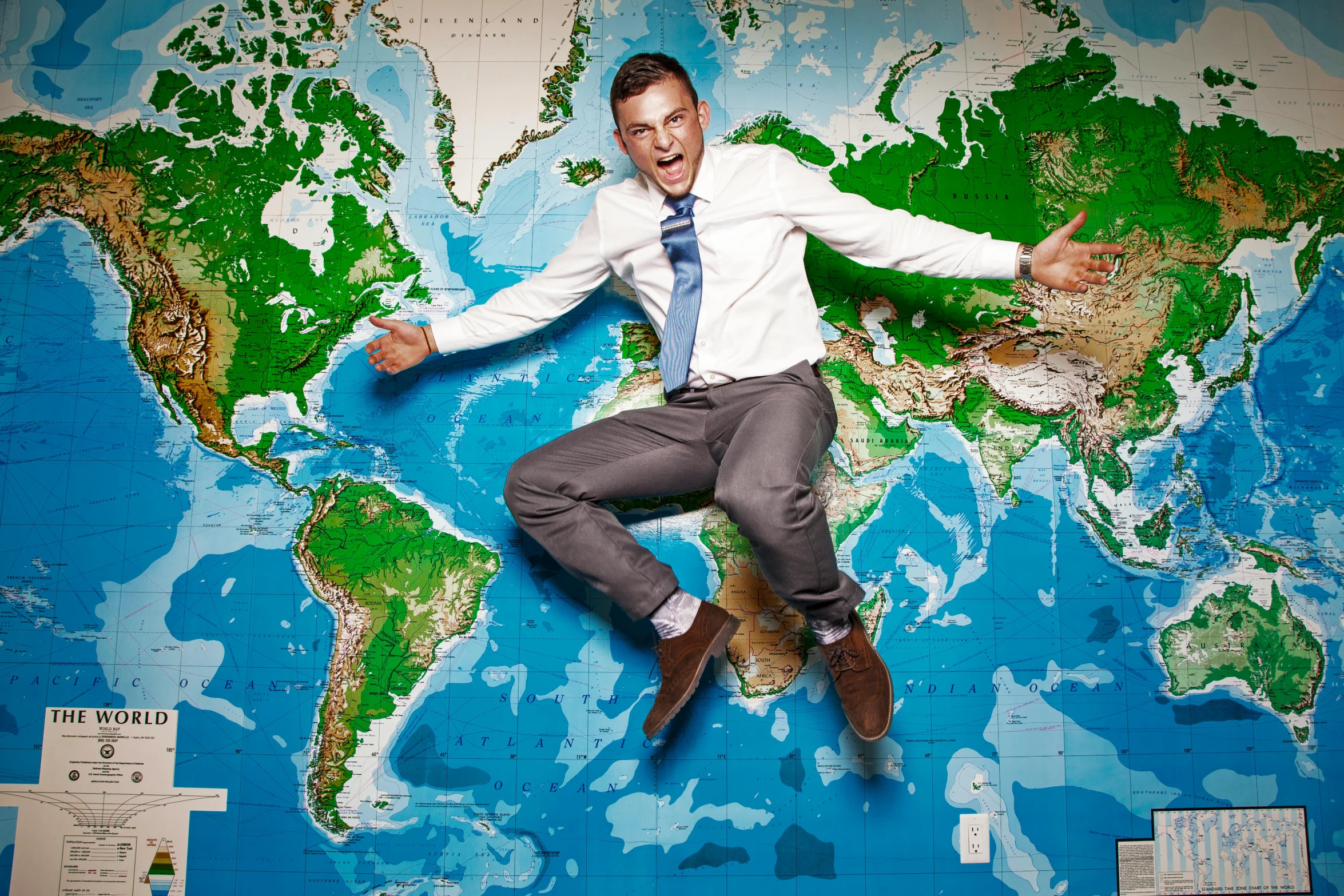 a man jumping in the air in front of a world map, inspired by Martin Schoeller, fantastic realism, bill nye the science guy, 64x64, platon, vitalik buterin