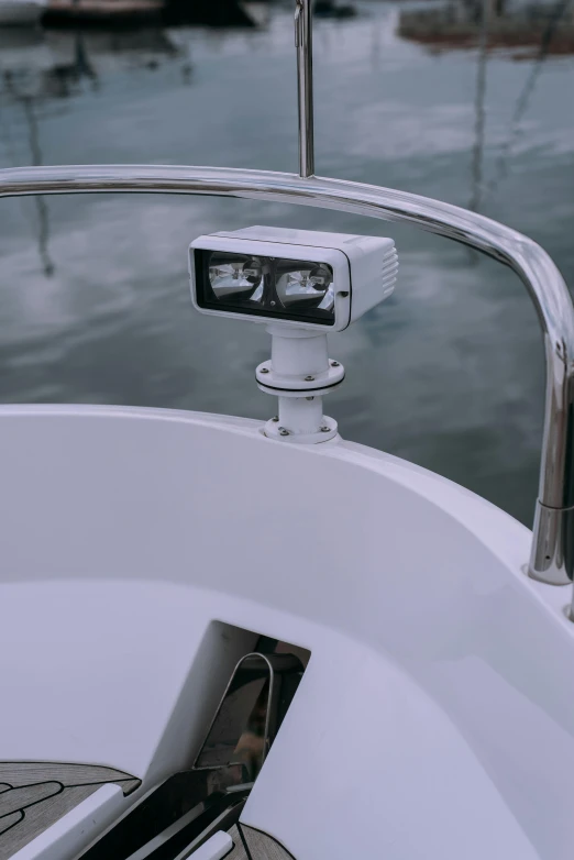 a camera mounted to the side of a boat, volumetric search lights, detailed product image, frontal shot, half image