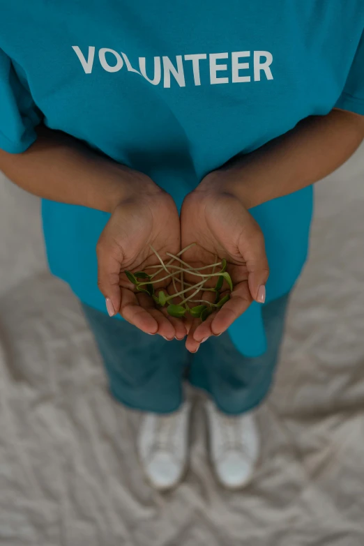 a person holding a handful of grass in their hands, an album cover, inspired by Andy Goldsworthy, unsplash, surgeon, ariel perez, covered with roots, avatar image