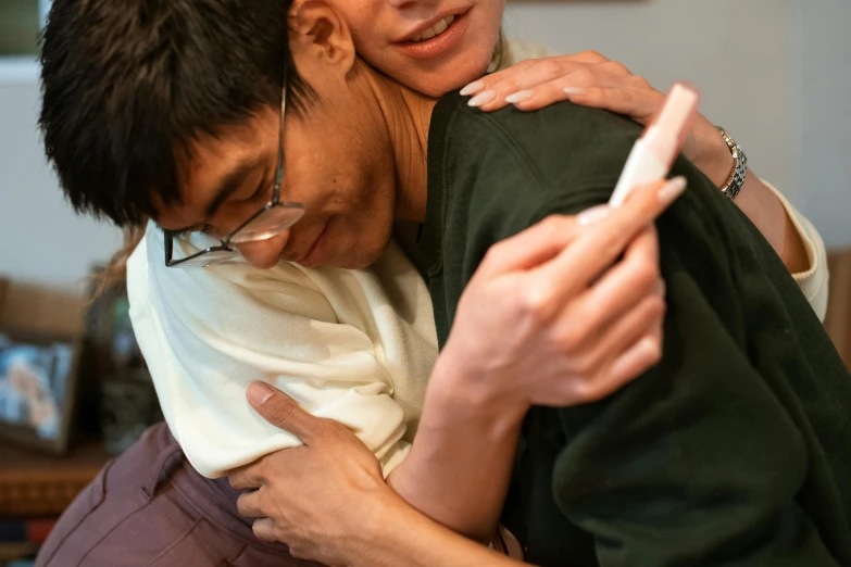 a couple of people that are hugging each other, by Nina Hamnett, unsplash, process art, asian male, holding an epée, ots shot, large and tall