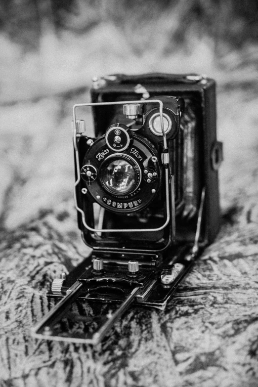 a black and white photo of an old camera, inspired by Germaine Krull, unsplash contest winner, medium format, 1 8 9 0 s photography, !! looking at the camera!!, colored photography