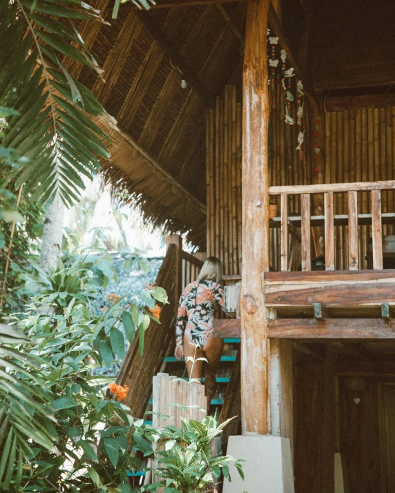 a couple of people that are standing in front of a house, unsplash, sumatraism, cozy treehouse bedroom, stairway, coconuts, thumbnail