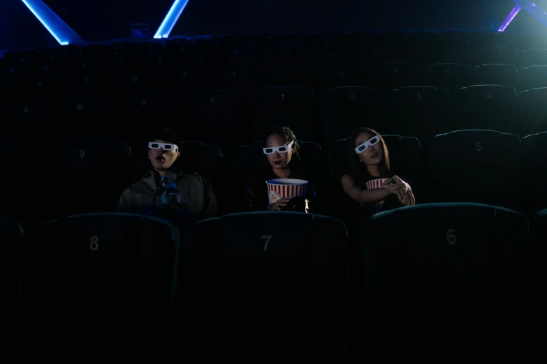 a group of people sitting in a theater wearing 3d glasses, a hologram, pexels contest winner, avatar image, movie lighting, cinematic. by leng jun, movie still of a tired