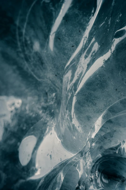 a man riding a wave on top of a surfboard, unsplash, lyrical abstraction, close up of single sugar crystal, desaturated blue, full of glass. cgsociety, monochrome