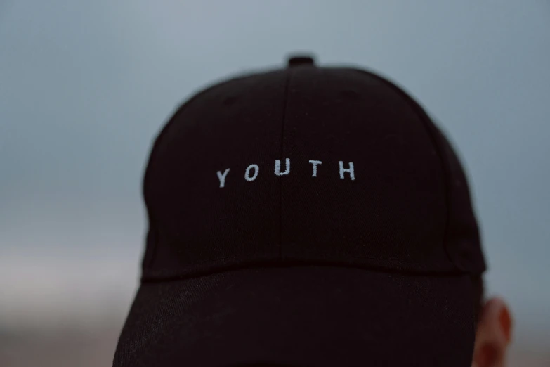 a man wearing a black hat with the word youth on it, unsplash, square, yung lean, 4 0 9 6, small