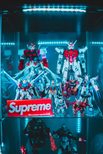 a display case with some action figures in it, a hologram, unsplash, suprematism, extreme gundam, supreme, red and cyan, instagram post