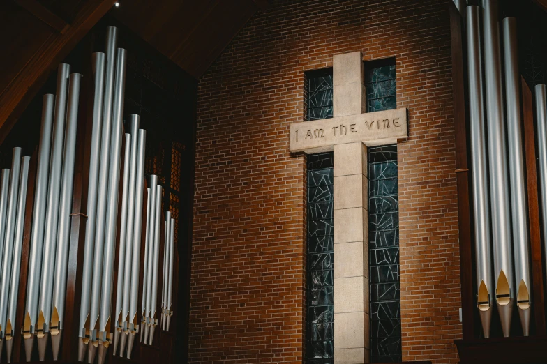 a church with a large pipe organ in front of it, unsplash, modernism, cross, brown, tyler west, decoration