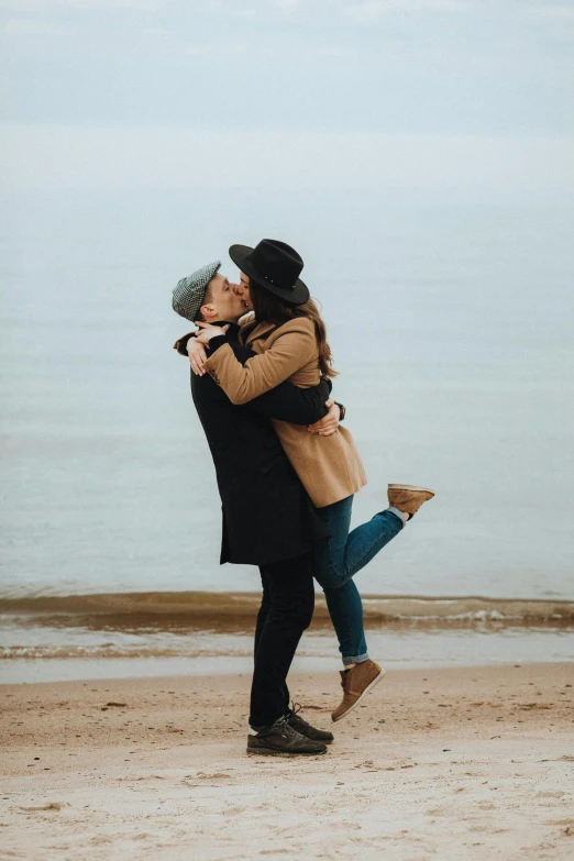 a man and woman kissing on the beach, pexels contest winner, plain background, fall season, 1 4 9 3, queen