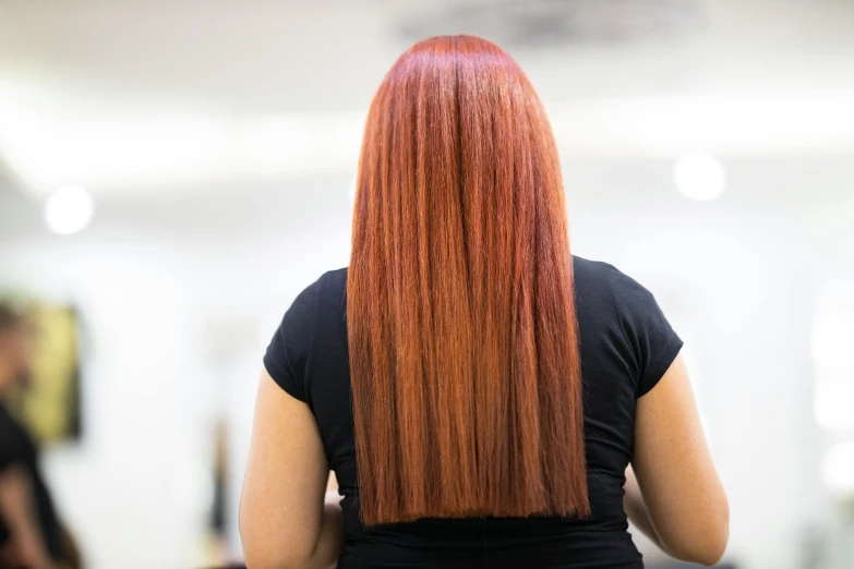 a woman with long red hair in a salon, pexels contest winner, back towards camera, straight camera view, full colour, rectangle