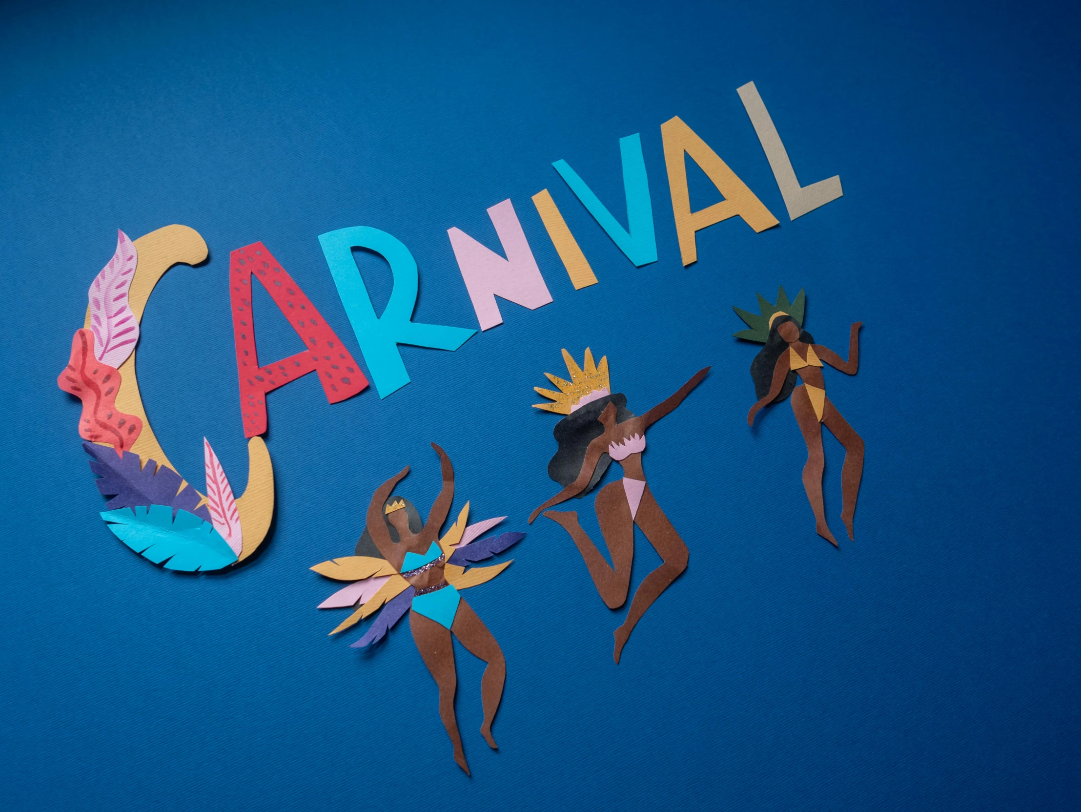 a group of people standing in front of a carnival sign, a cartoon, by Julia Pishtar, pexels contest winner, paper art, caribbean, on a dark background, cut out of cardboard