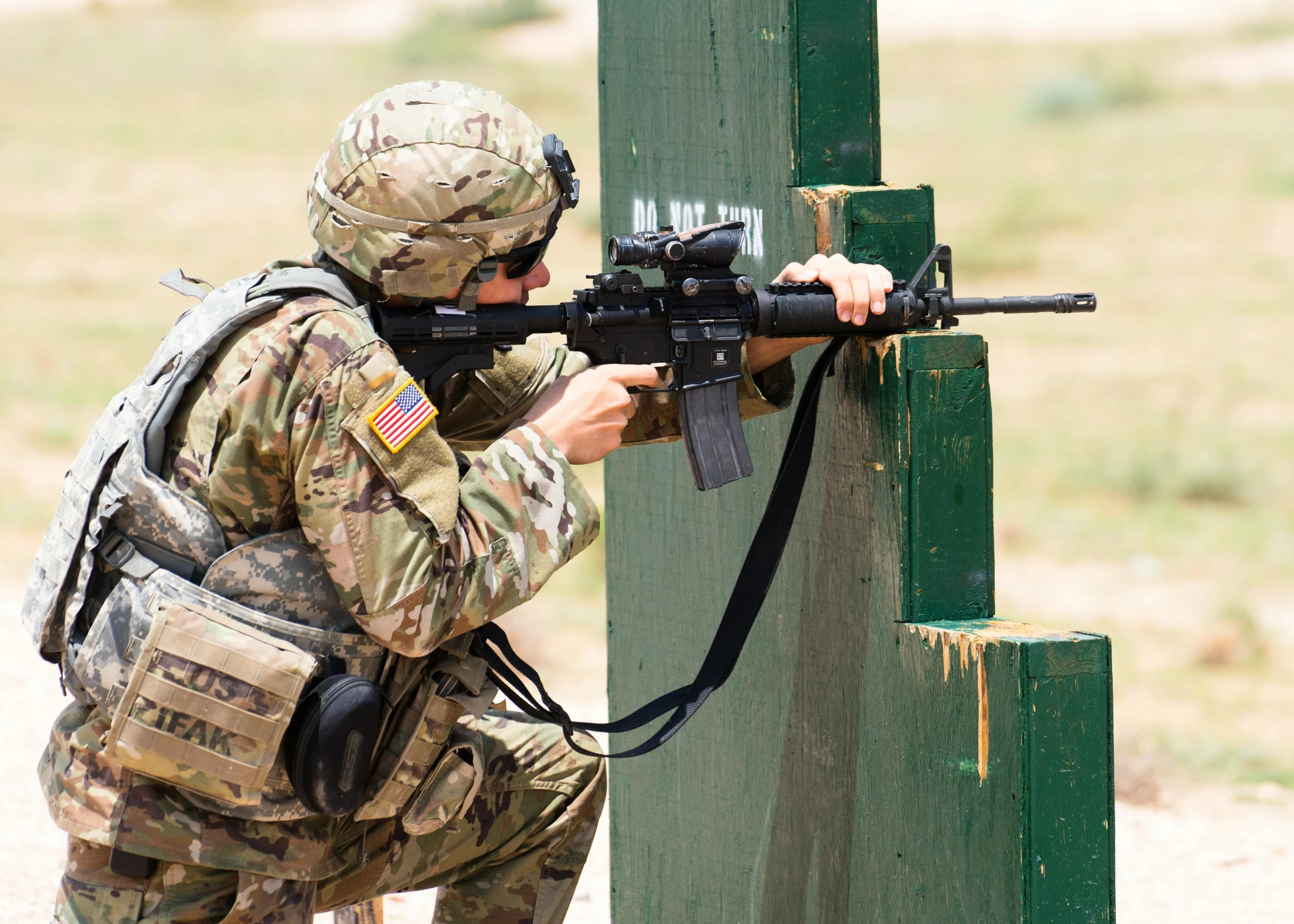 a soldier is aiming with a machine gun, not cropped, boot camp, instagram post, high resolution