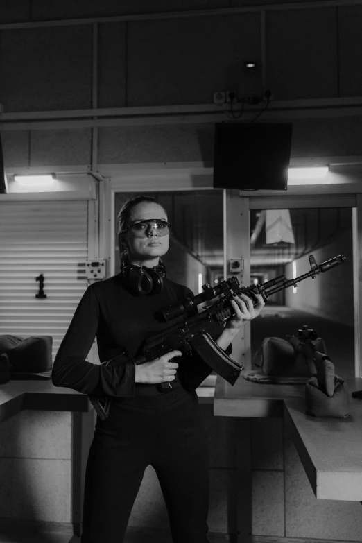 a black and white photo of a man holding a gun, inspired by Carl Gustaf Pilo, gordon freeman as a woman, in intergalactic hq, cold war, photo courtesy museum of art