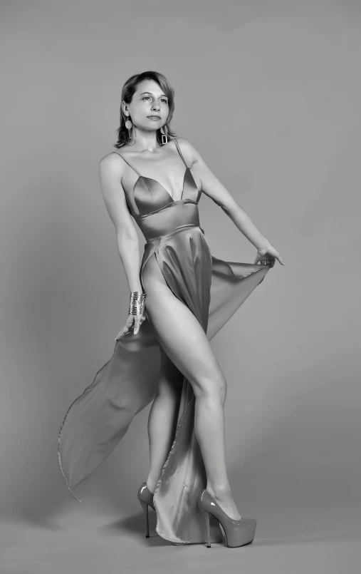 a black and white photo of a woman in a dress, an album cover, by Gavin Hamilton, featured on zbrush central, zendaya, lascivious pose, translucent silky dress, silver garment