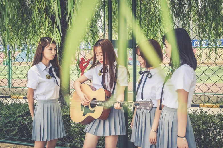 a group of young women standing next to each other, an album cover, inspired by Kim Jeong-hui, unsplash, danube school, guitar solo, dressed as schoolgirl, trending on cgstation, asian girl