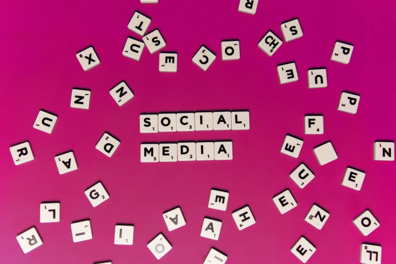 scrabbles spelling social media on a pink background, a photo, unsplash, ad image