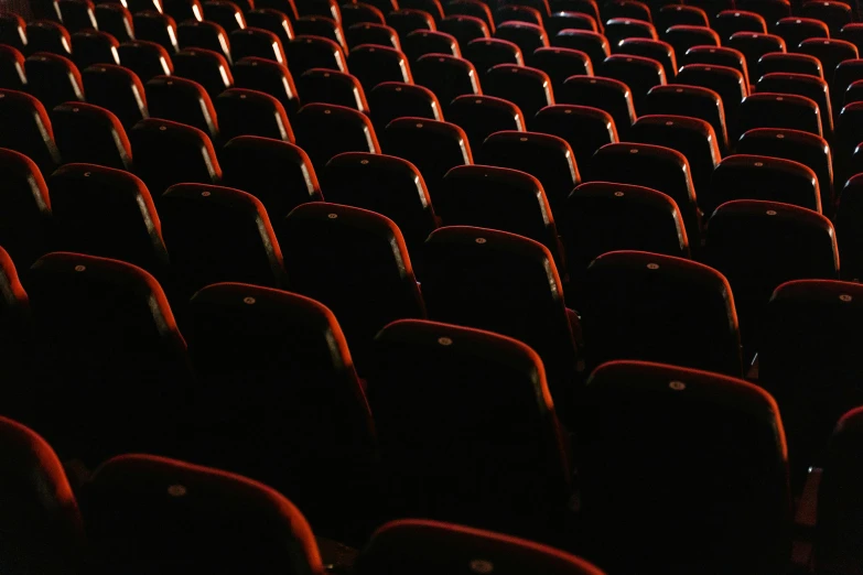 an empty theater with rows of red seats, an album cover, by Elsa Bleda, pexels, with a black background, instagram picture, contain, actors