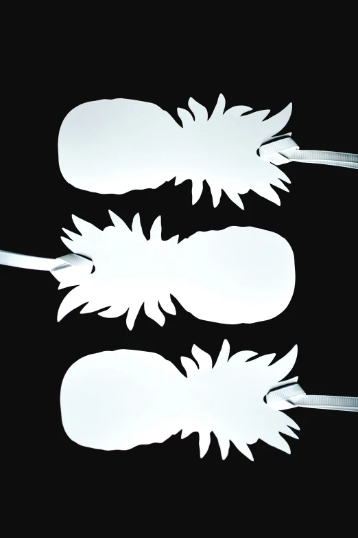 three pineapples cut out of paper on a black background, by Allen Jones, conceptual art, glossy white metal, floggers, made out of shiny white metal, 3 - piece