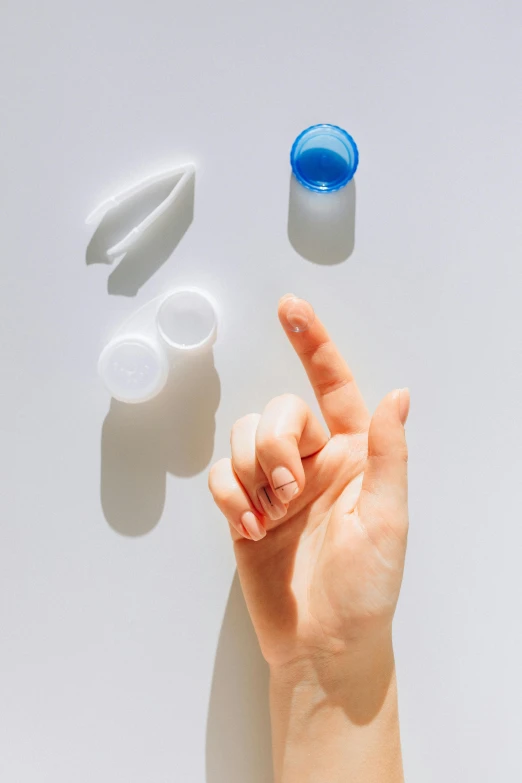 a close up of a person's hand making a peace sign, plasticien, small glasses, contracept, product design shot, grey contacts