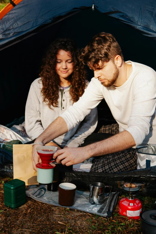 a man and a woman sitting in front of a tent, two cups of coffee, cooking it up, gen z, album