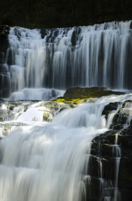 a waterfall in the middle of a forest, hurufiyya, zoomed in, idaho, sandfalls, close-up photo