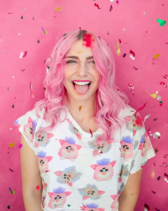 a woman with pink hair standing in front of a pink wall, confetti, smiling maniacally, wavy hair spread out, trending on pinterest. com