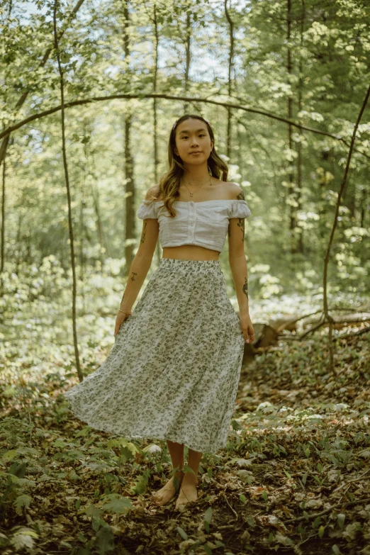 a woman standing in the middle of a forest, unsplash, renaissance, wearing crop top and miniskirt, midi skirt, slide show, cottagecore