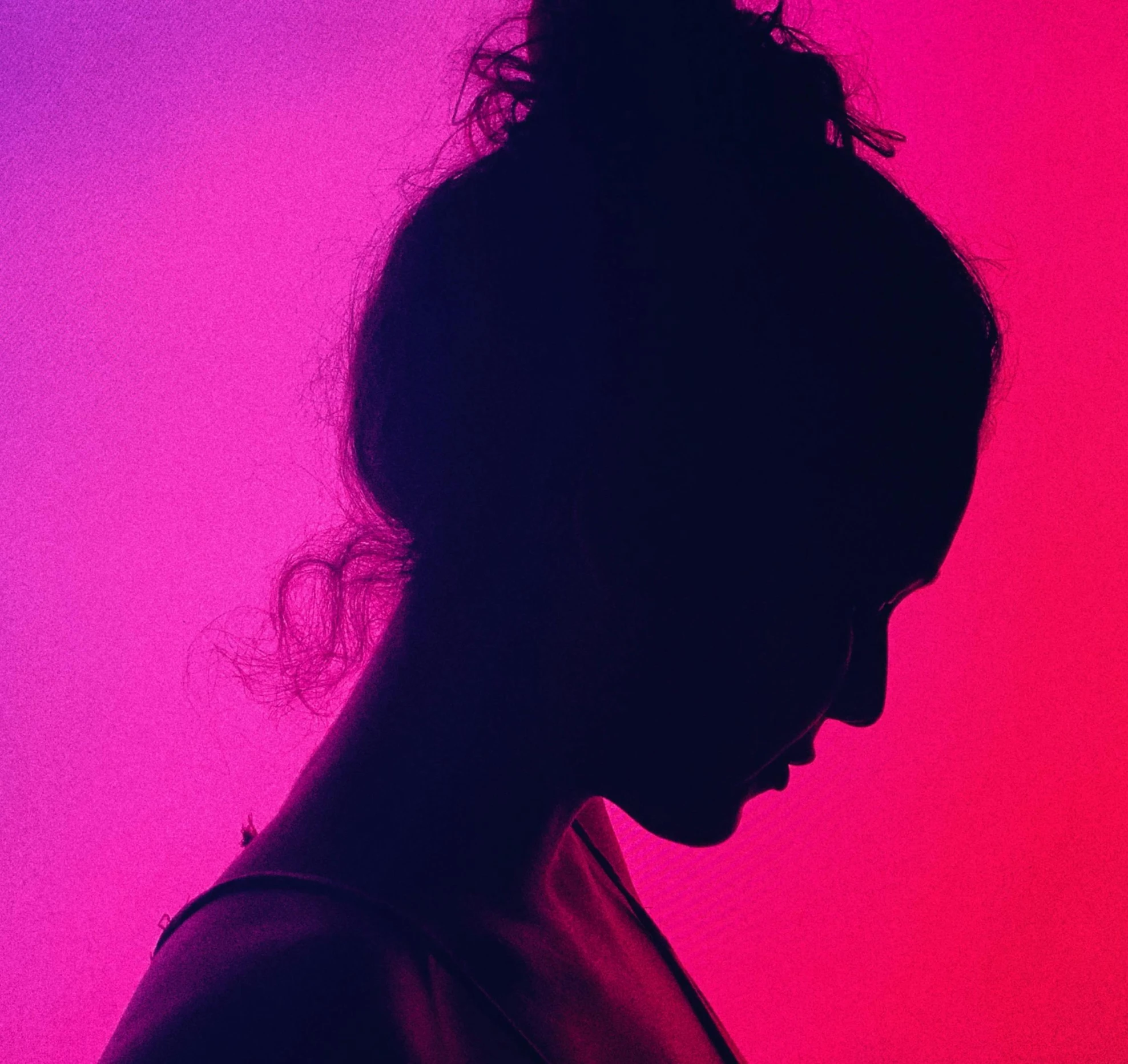 a silhouette of a woman using a cell phone, pexels contest winner, antipodeans, magenta and crimson and cyan, depressed girl portrait, girl with messy bun hairstyle, light study