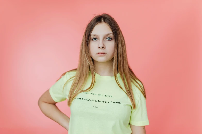 a woman standing with her hands on her hips, by Julia Pishtar, pexels contest winner, tshirt, lime green, sadie sink, self - aware
