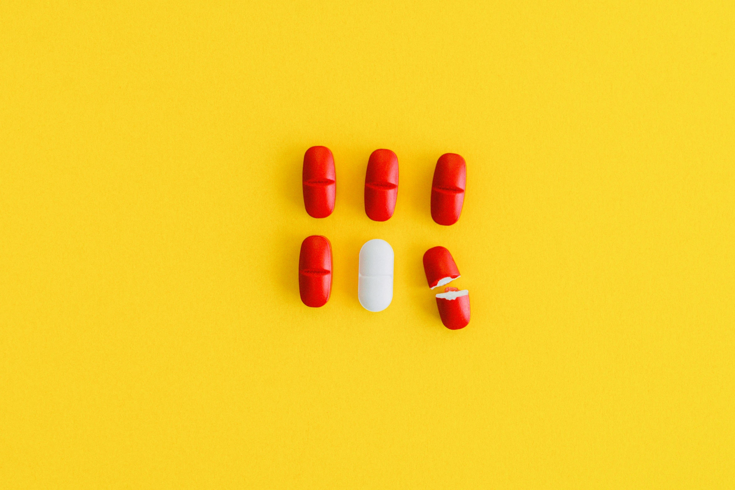 red and white pills on a yellow background, by Julia Pishtar, antipodeans, minimalist photorealist, fan favorite, red hoods, 9