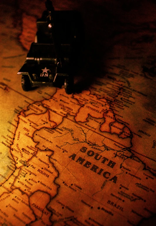 a toy train sitting on top of a map, square, colonial expedition, dim lit, world war ii