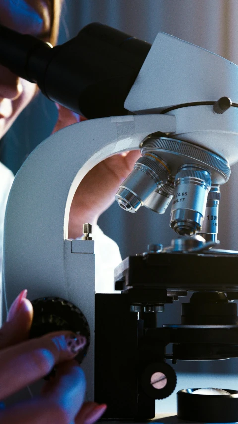 a close up of a person looking through a microscope, a microscopic photo, shutterstock, stood in a lab, ap photo, thumbnail, concern