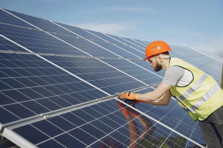 a man standing on top of a roof next to a solar panel, a stock photo, shutterstock, slide show, green, grey, performing