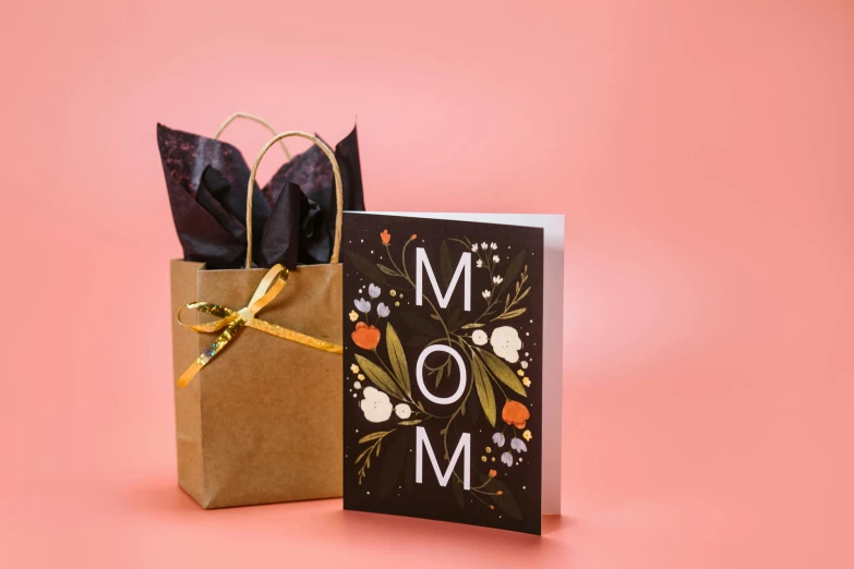 a mother's day card and gift bag on a pink background, by Julia Pishtar, modernism, on a black background, monsoon, abcdefghijklmnopqrstuvwxyz, hood