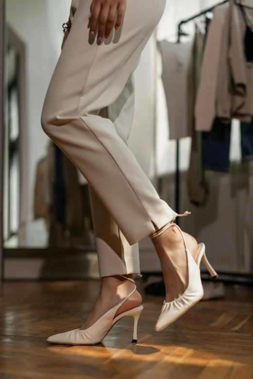 a woman standing on top of a hard wood floor, a picture, by Raphaël Collin, trending on pexels, renaissance, white soft leather model, khakis, silk shoes, chiffon