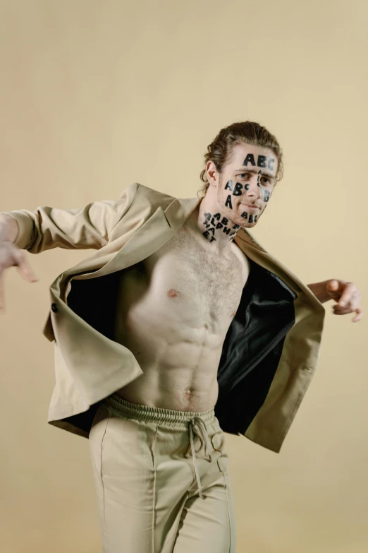 a man with a face painted to look like a zombie, an album cover, by Caro Niederer, trending on pexels, neo-dada, brown clothes, humanoid cheetah, jacket over bare torso, yung lean