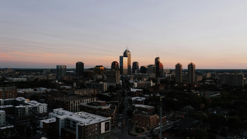 an aerial view of a city at sunset, by Carey Morris, unsplash contest winner, hurufiyya, midwest town, low quality photo, clear skies in the distance, film photo