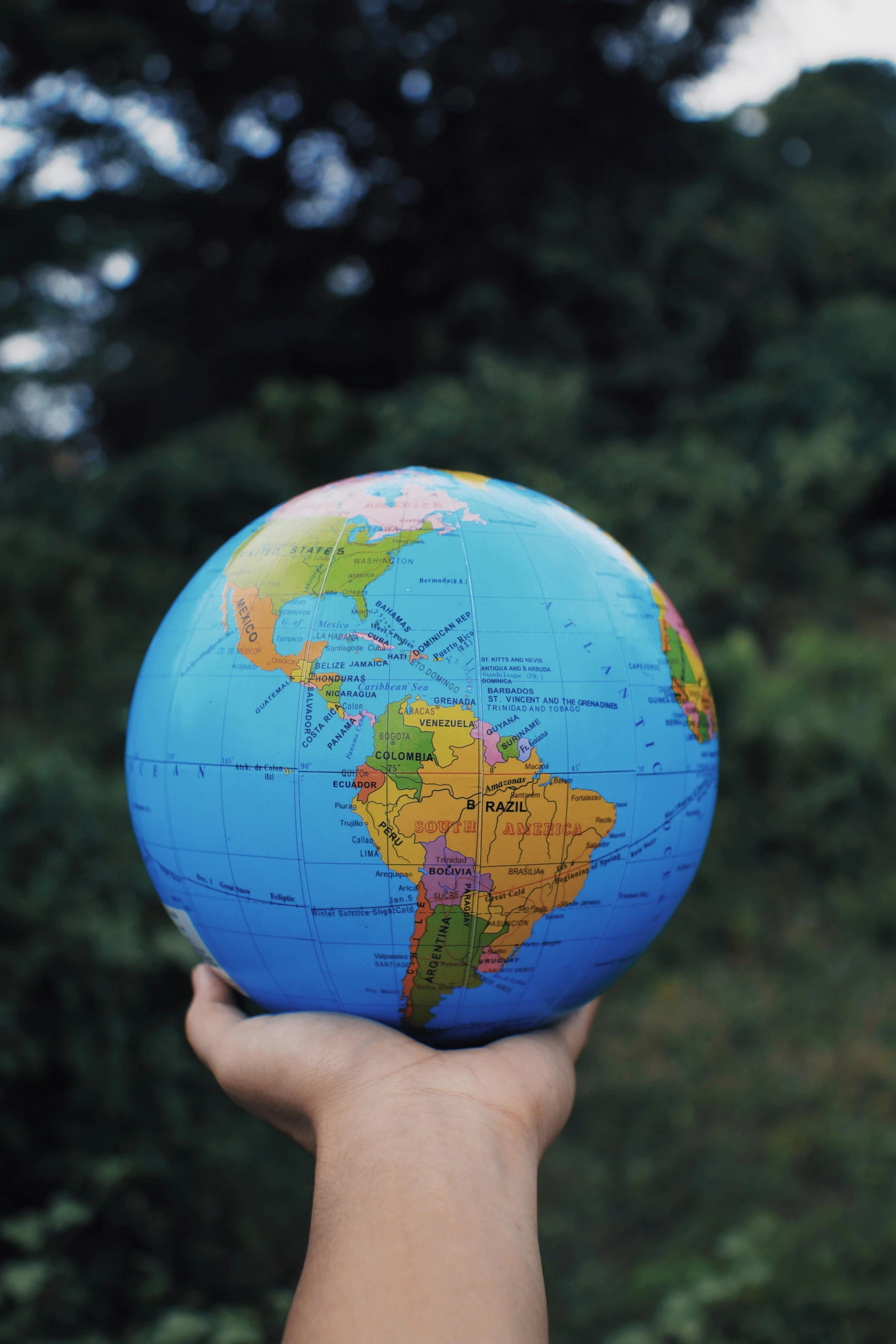 a person holding a small globe in their hand, an album cover, by Robert Medley, pexels, national geograpic, round-cropped, contain, schools