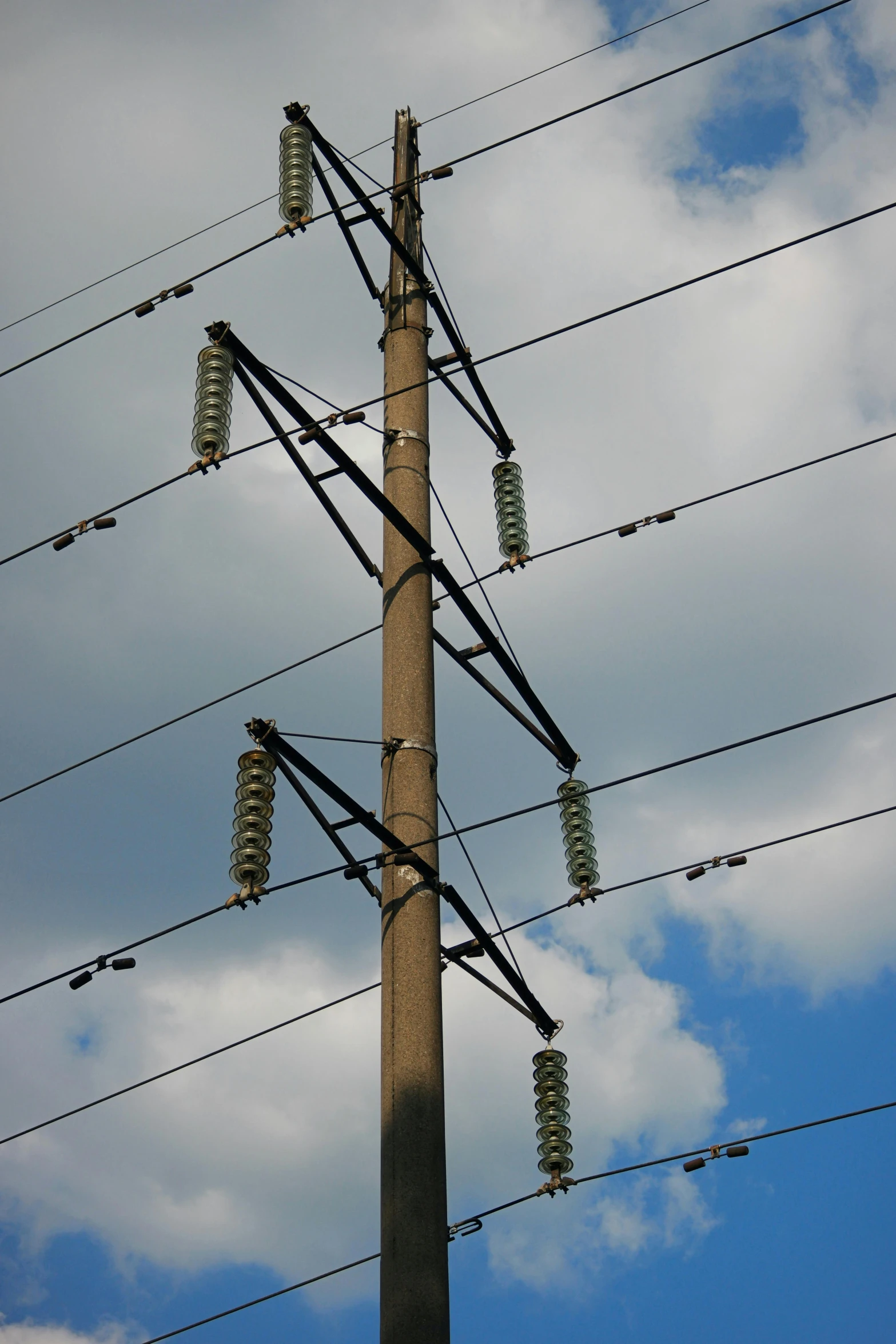 a close up of a telephone pole on a cloudy day, by Joe Stefanelli, renaissance, lines of energy, stacks, green, oh