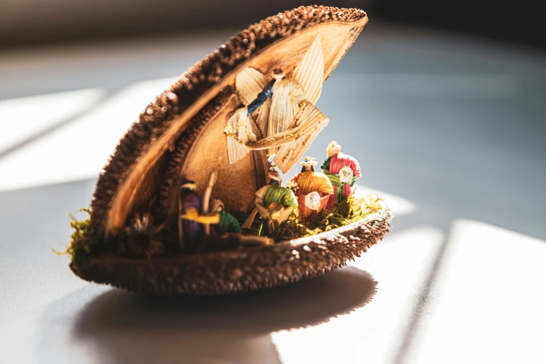 a close up of a small figurine on a table, by Joseph Severn, trending on unsplash, renaissance, coconuts, fully decorated, light inside the hut, cornucopia