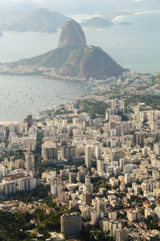 a view of a city with a mountain in the background, cristo redentor, birdseye view, floating buildings, zoomed out to show entire image