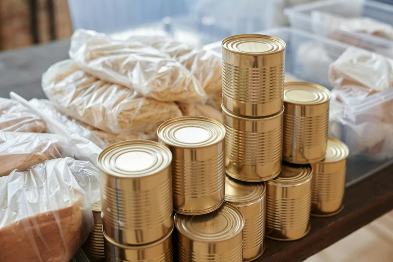 a bunch of tins sitting on top of a table, pexels, golden ribbons, local foods, 4l, brown