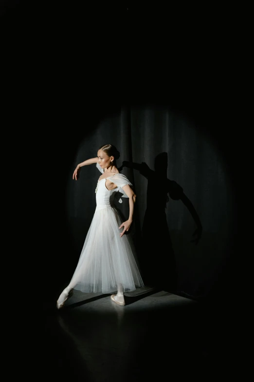 a woman in a white dress standing on a stage, a picture, by Elizabeth Polunin, unsplash, mariko mori, studio photo, photographed for reuters, shadow