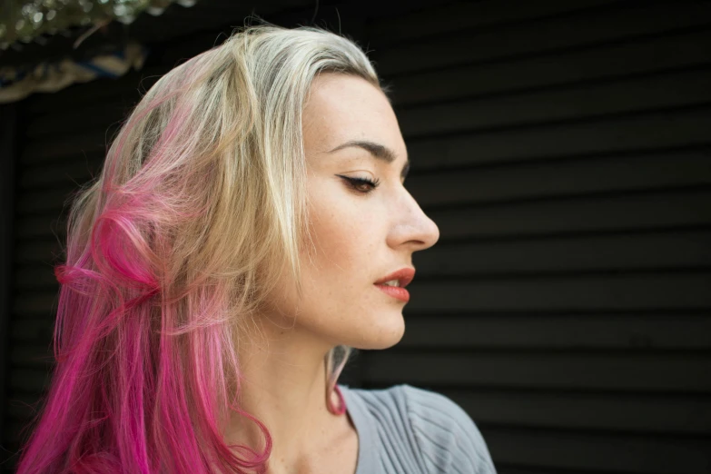 a close up of a person with pink hair, inspired by Elsa Bleda, trending on pexels, renaissance, side portrait rugged girl, blonde and attractive features, young woman looking up, coloured