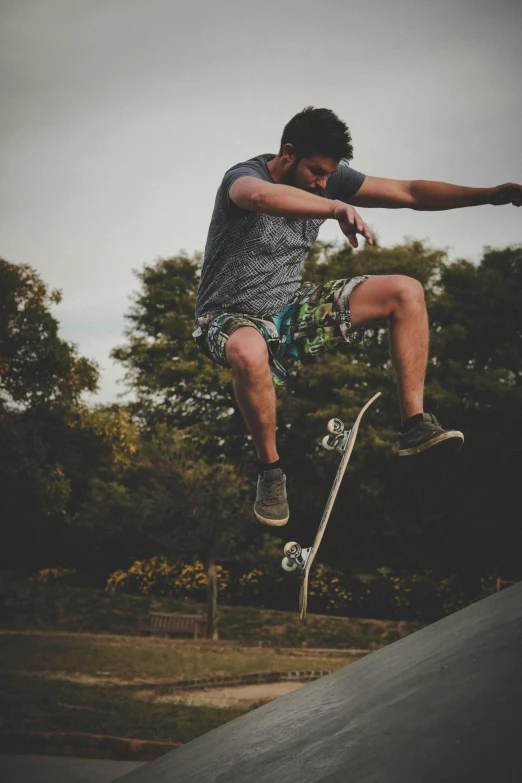 a man flying through the air while riding a skateboard, pexels contest winner, happening, camo, wearing a tank top and shorts, nature outside, low quality photo