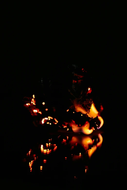 a person riding a motorcycle in the dark, photo of a camp fire underwater, made of glowing wax and ceramic, promo image, on black paper