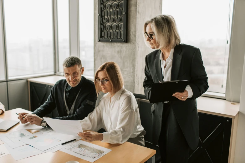 a group of people sitting around a wooden table, sitting on a desk, profile image, professional branding, top selection on unsplash