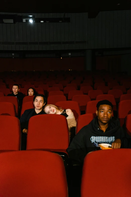 a group of people sitting in a movie theater, an album cover, pexels contest winner, portrait pose, gen z, cinestill eastmancolor, press shot