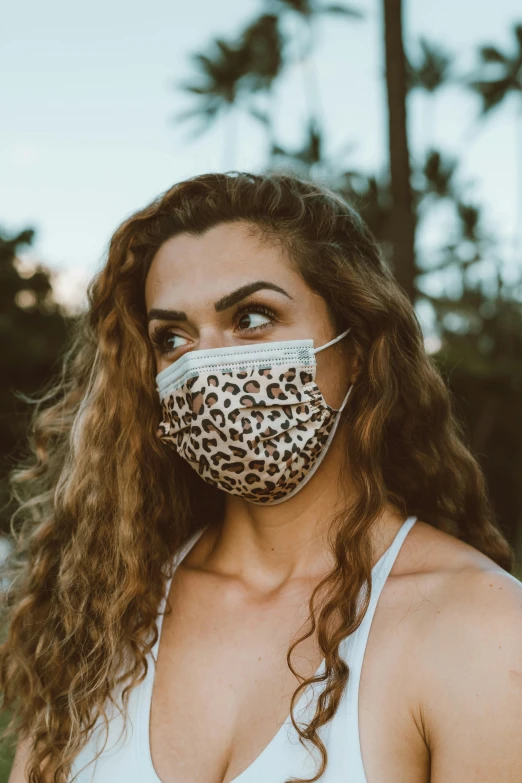 a woman wearing a leopard print face mask, earthy, f / 2 0, maui, superior
