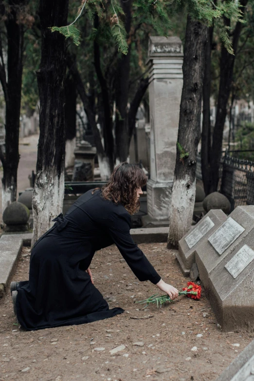 a woman kneeling down in front of a grave, unsplash, nadezhda tikhomirova, profile image, multiple stories, greek